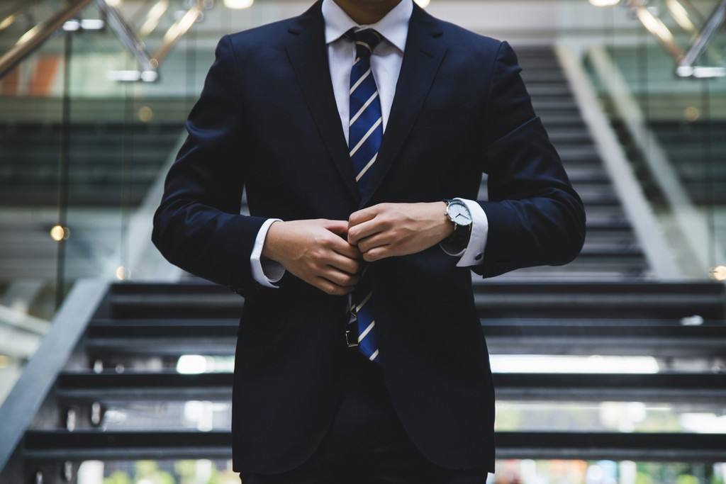 Professional in a suit on a modern office staircase